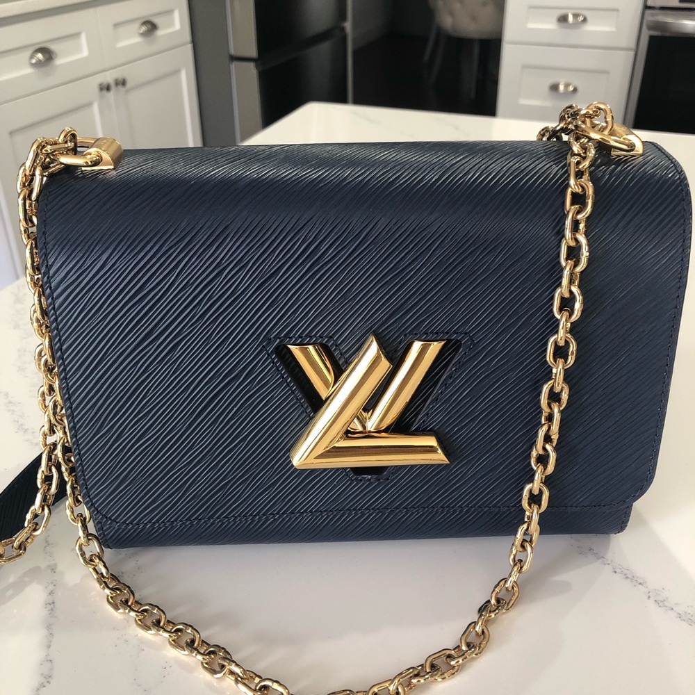 Luxurious Louis Vuitton Navy Crossbody Bag with Gold Chain and hand mirror.